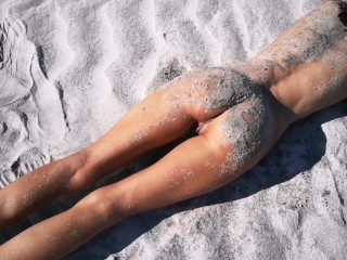 Stranger reveals a great tanned thin brunette on a nudist seashore and offers her a sizzling piss