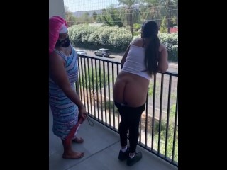 Black lady paddles Latina lady on balcony for no longer cleansing up